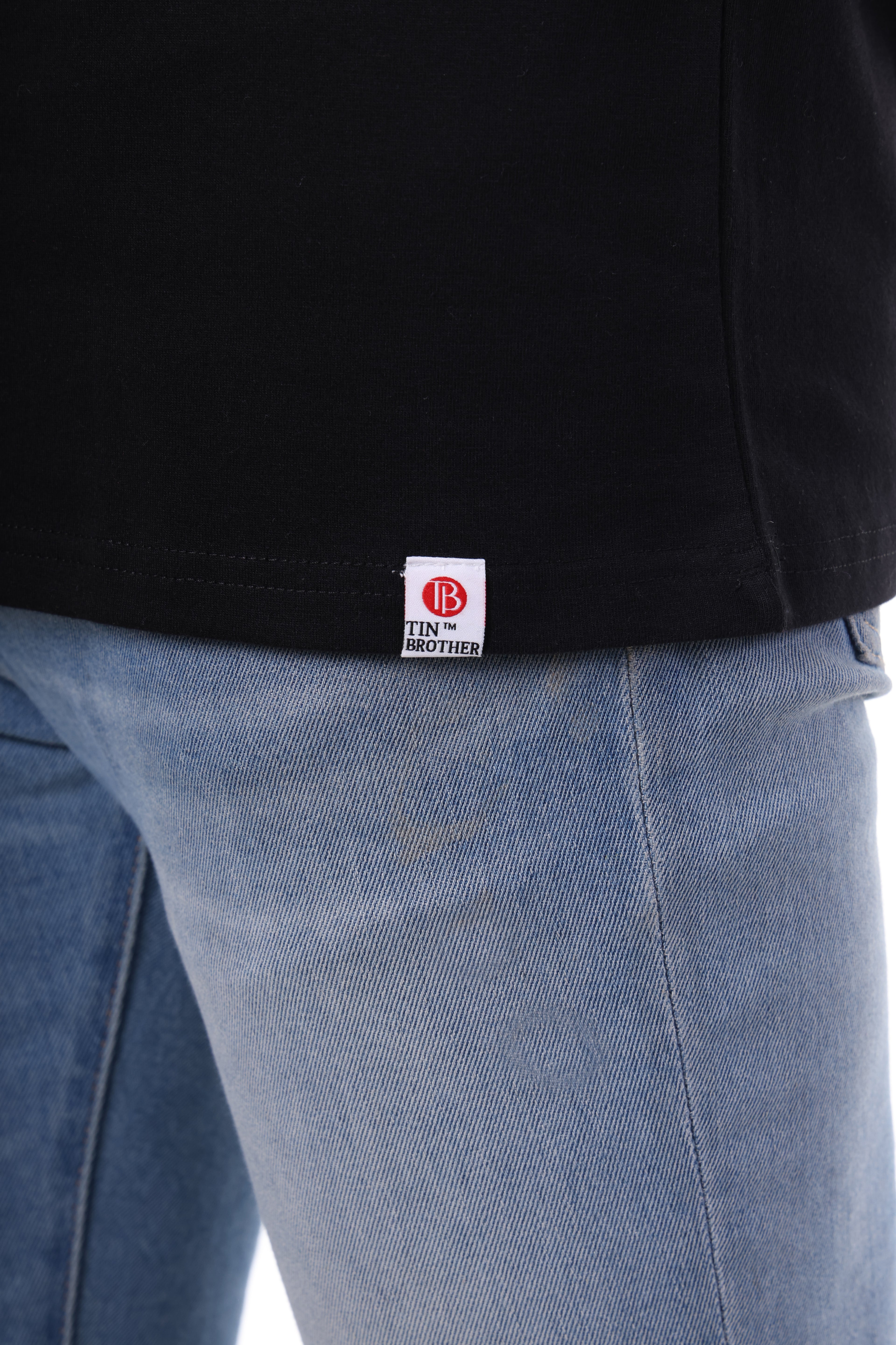 Brand tag close-up on Tin Brother t-shirt – stitched cotton label for clean branding

